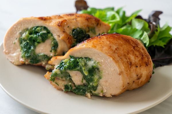 Neir Family Kitchen Recipe - Spinach Parmesan Chicken Rollatini on a plate with a side of salad