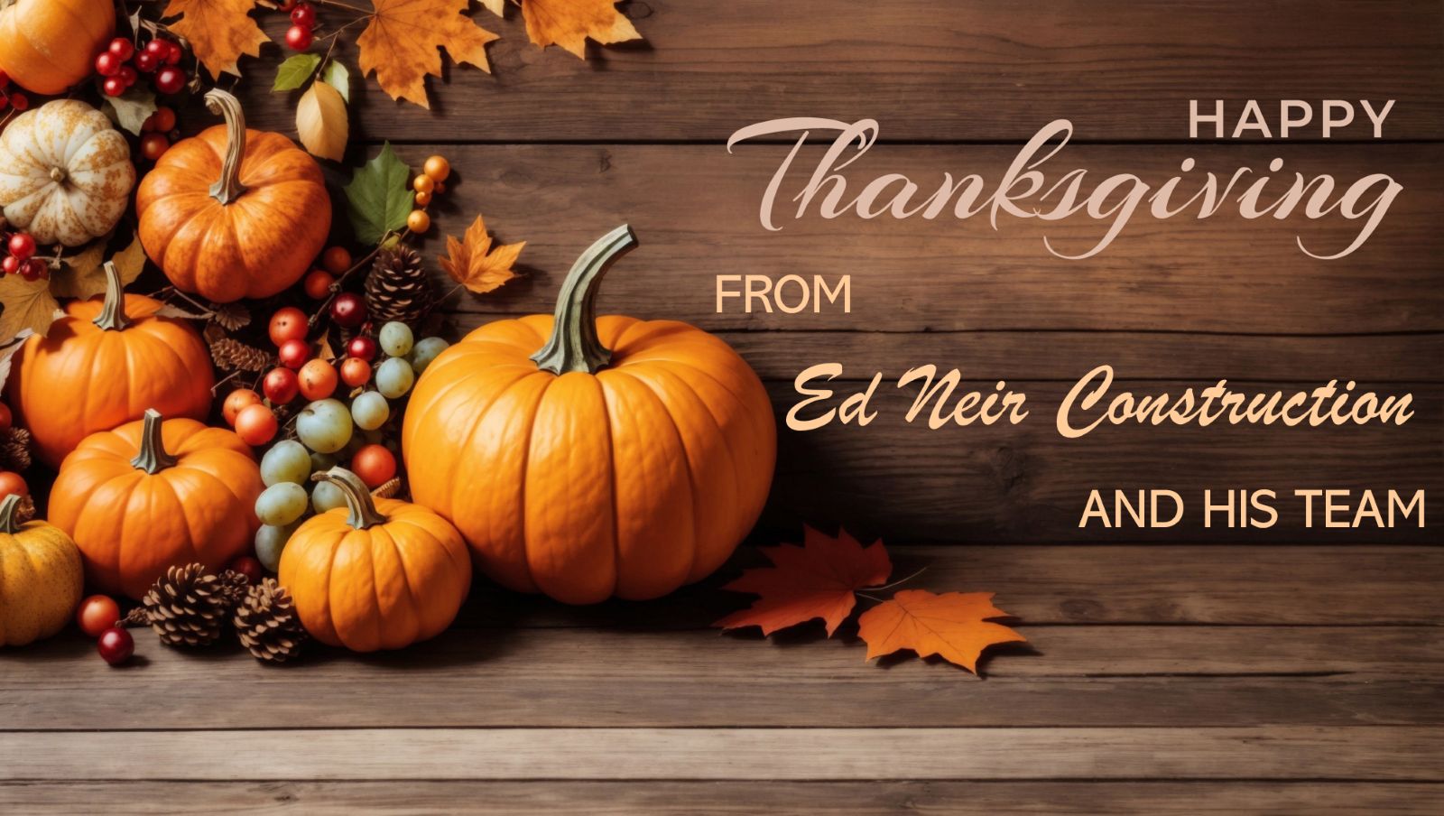 Ed Neir Construction wishes everyone a Happy Thanksgiving - planks of wood with pumpkins, fall leaves, and grapes