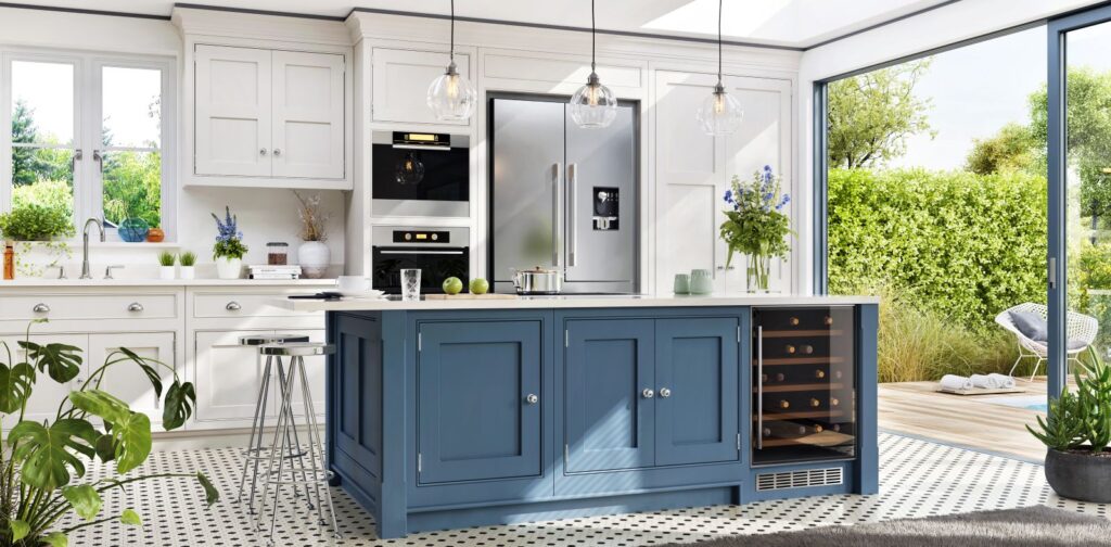 Ed Neir Construction builds integrated indoor/outdoor kitchens - white and blue shaker cabinets, island with wine chiller, pendant lighting + large glass door to pool/patio.