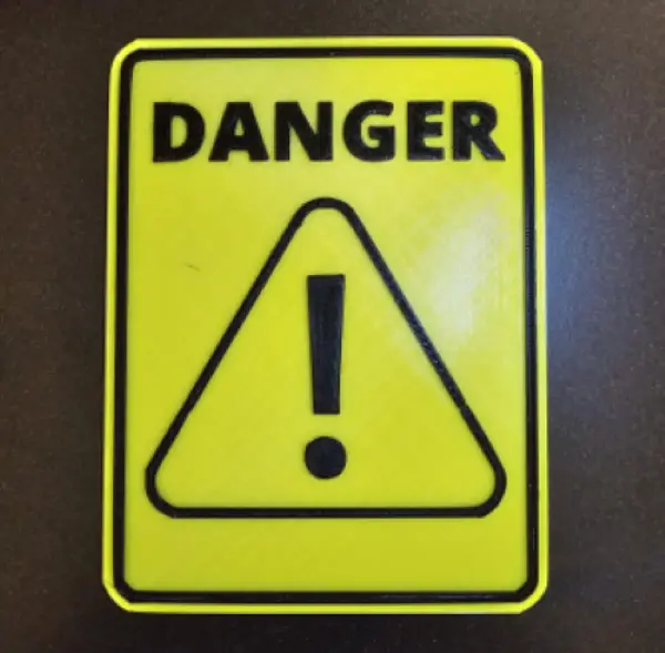 Yellow caution sign warns of danger - Ed Neir Construction says know the 10 warning signs to avoid imposter contractors.