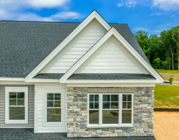 Ed Neir Construction helps homeowners achieve stunning architectural depth: home has linear dry-stack, variegated earth-tone manufactured stone veneer for highest ROI (90%-96%).