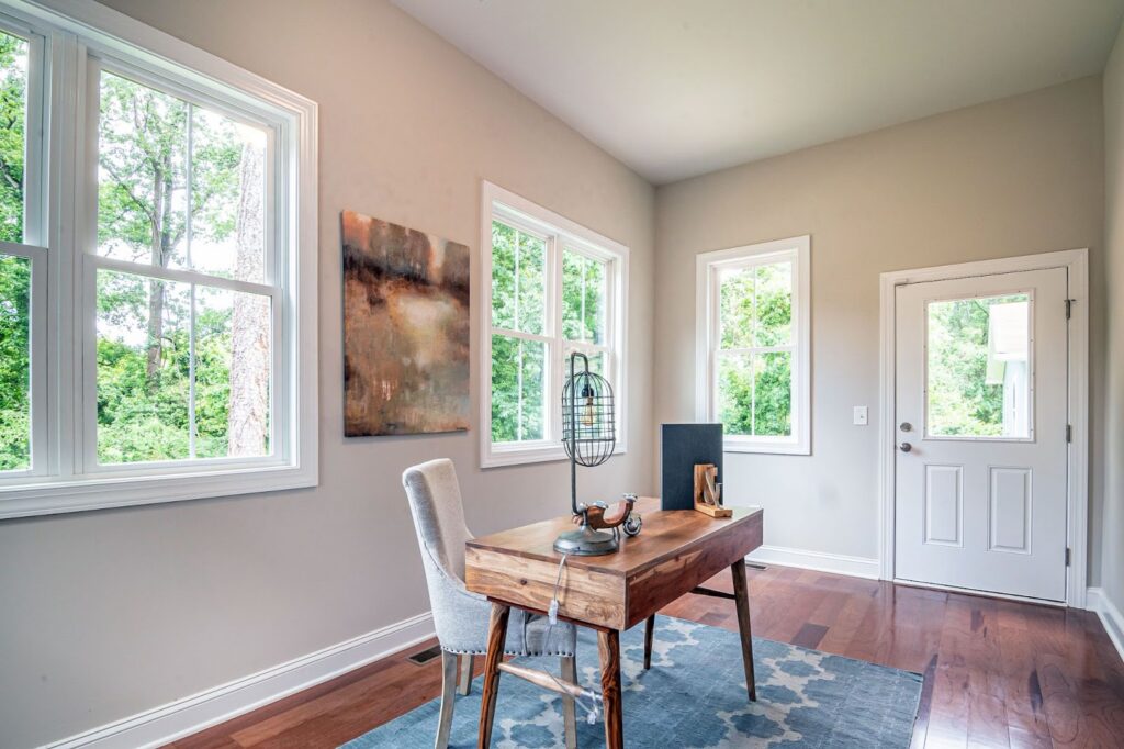 Ed Neir Construction transforms underutilized space to a flex suite. Room with 3 windows & door on 1st floor used as an office.